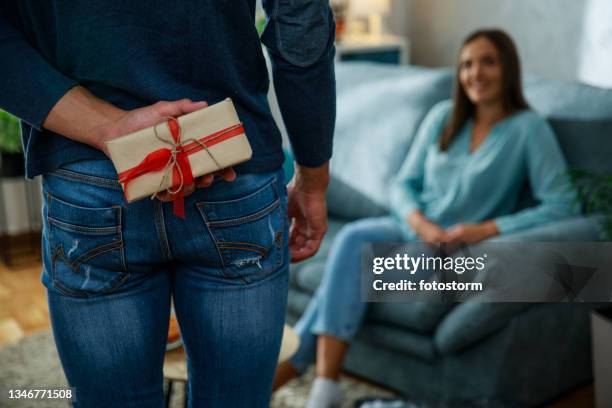 man about to surprise his girlfriend with a gift box - hands behind back stock pictures, royalty-free photos & images