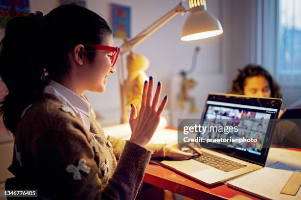 girl is e-learning and video conferencing at home - zoom school stock pictures, royalty-free photos & images