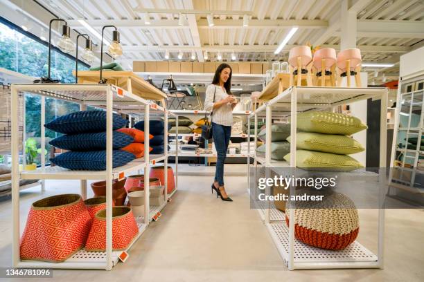 happy woman shopping at a home decor store - furniture store stockfoto's en -beelden