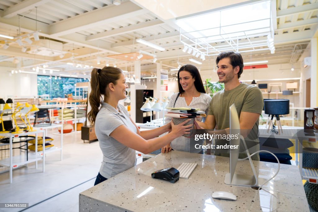 Retail clerk helping customers shopping at a furniture store