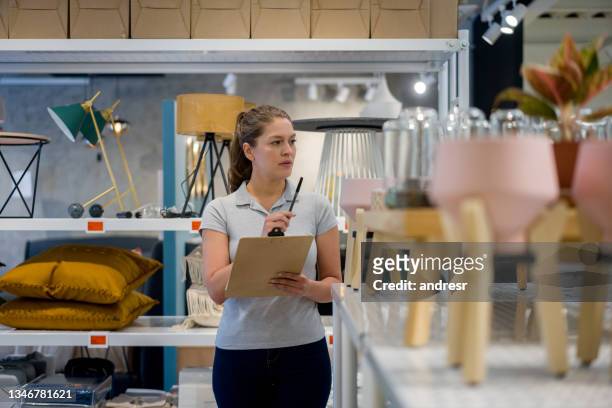 saleswoman working at a furniture store doing the inventory - furniture shop stock pictures, royalty-free photos & images