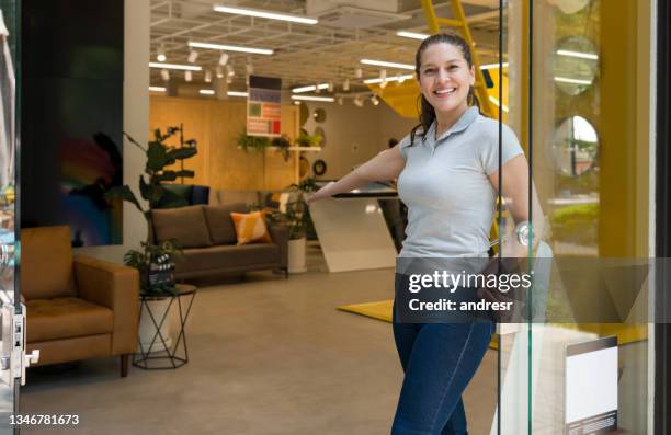 happy saleswoman welcoming customers at a furniture store - opening event stock pictures, royalty-free photos & images
