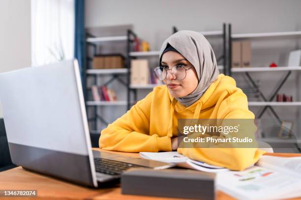 middle eastern girl attending a video call - islam stock pictures, royalty-free photos & images