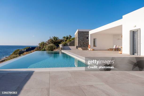 luxury minimalist house with swimming pool and beautiful sea view. - summer home stock pictures, royalty-free photos & images