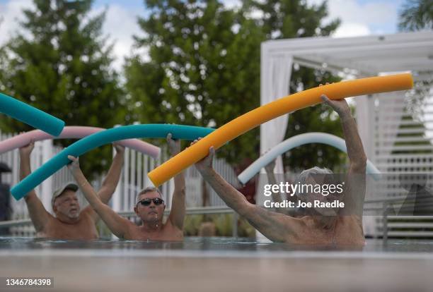 Kevin Soyt, Robert Hamilton and Dave Bayer participate in a water aerobics class in the John Knox Village Continuing Care Retirement Community pool,...