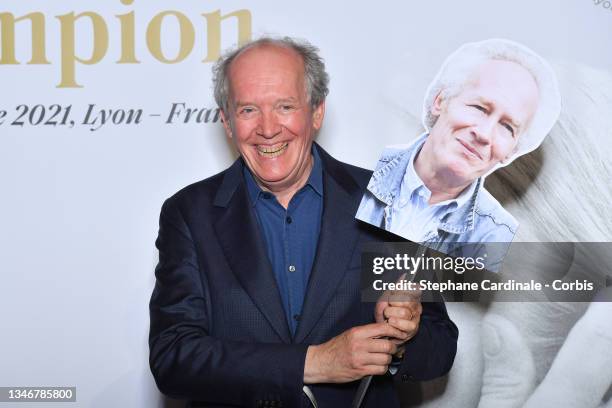 Luc Dardenne poses with a picture of his brother Jean-Pierre Dardenne during the Lumiere Award Ceremony during the 13th Film Festival Lumiere In Lyon...