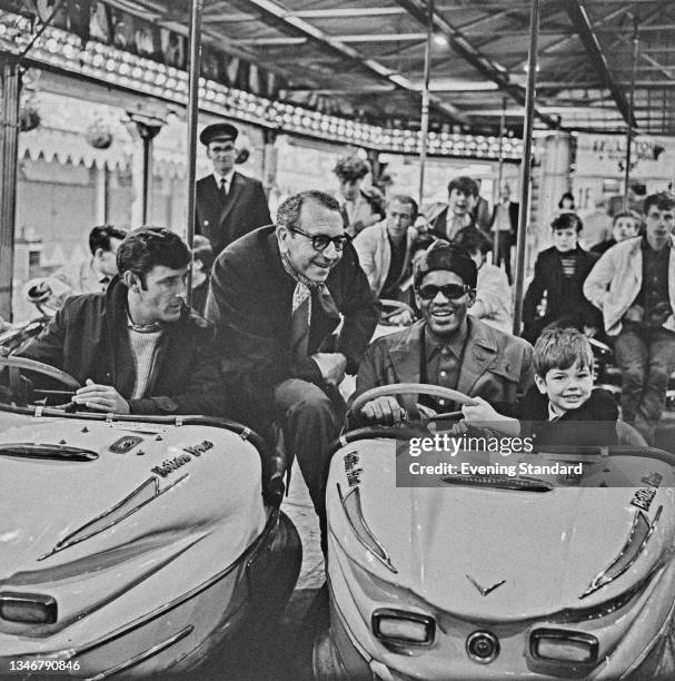 From left to right, actor Tom Bell , actor and director Paul Henreid , singer and pianist Ray Charles and child actor Piers Bishop during the filming...