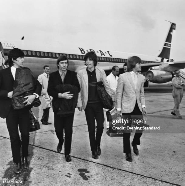 British rock band the Rolling Stones arrive back at London Airport after their first tour of the United States, UK, 24th June 1964. From left to...