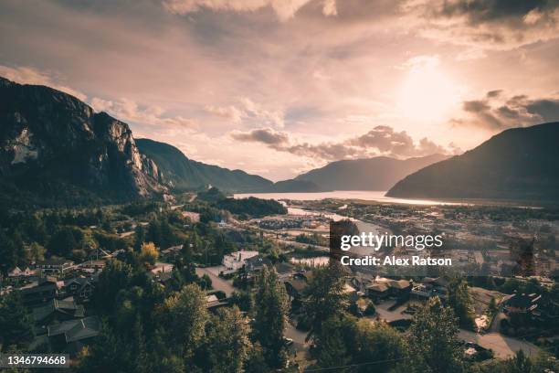 aerial view of squamish, british columbia with golden coloured backlighting - suburban background stock pictures, royalty-free photos & images