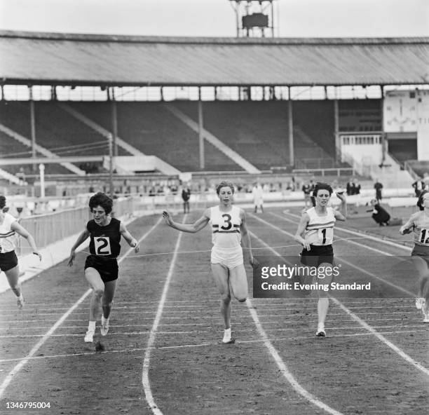 From left to right, British athletes Daphne Arden, Mary Rand and Dorothy Hyman compete in the women's 100 yard dash during the WAAA Championships at...