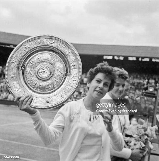 Maria Bueno of Brazil holds the Venus Rosewater Dish after defeating the defending champion Margaret Smith of Australia in the Women's Singles final...