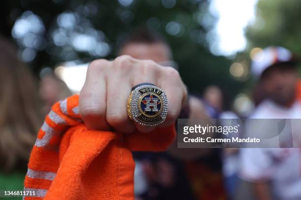 Houston Astros fan wears a replica World Series ring before their game against the Boston Red Sox before Game One of the American League Championship...