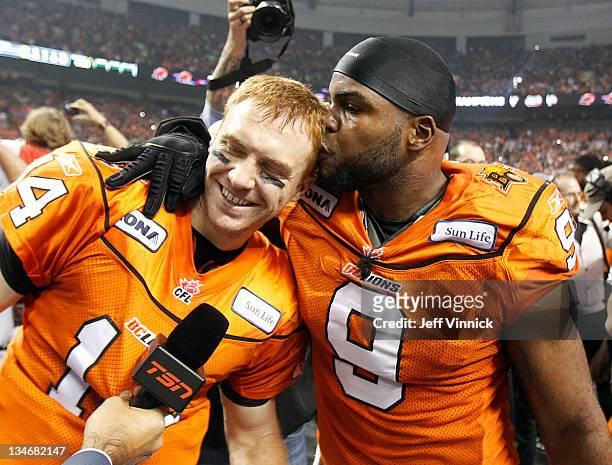 Travis Lulay of the BC Lions is kissed by teammate Keron Williams after winning the CFL 99th Grey Cup against the Winnipeg Blue Bombers November 27,...