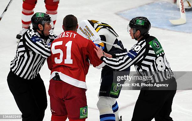 Jon Mirasty of the Vityaz and Josh Gratton of the Barys tangled up as they fight while referee try to hold during the game between Barys and Vityaz...