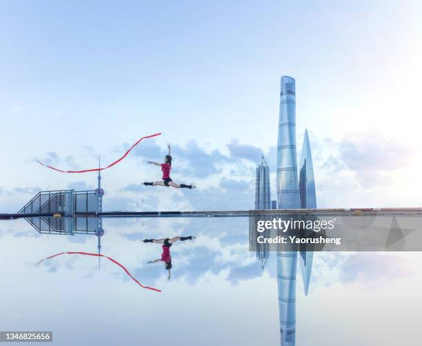 young female ballet dancer dancing with a red ribbon on a rooftop in shanghai,china - shanghai tower shanghai photos et images de collection