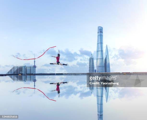 young female ballet dancer dancing with a red ribbon on a rooftop in shanghai,china - wide angle city stock pictures, royalty-free photos & images