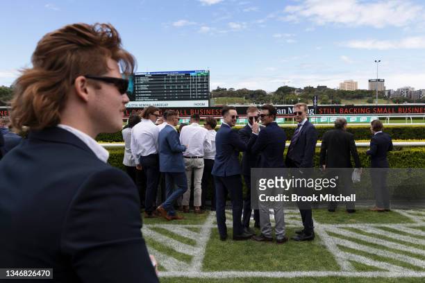 Man sporting a sleek haircut known locally as a 'Mullet' walks through a public area during the Everest race day at Royal Randwick Racecourse on...