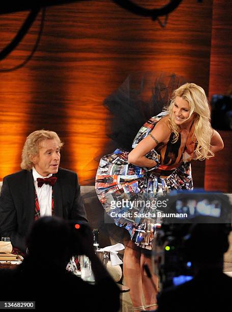 Michelle Hunziker presents a surprise dress to Thomas Gottschalk make out of pictures from his outfits during the 199th "Wetten dass...?" show at the...