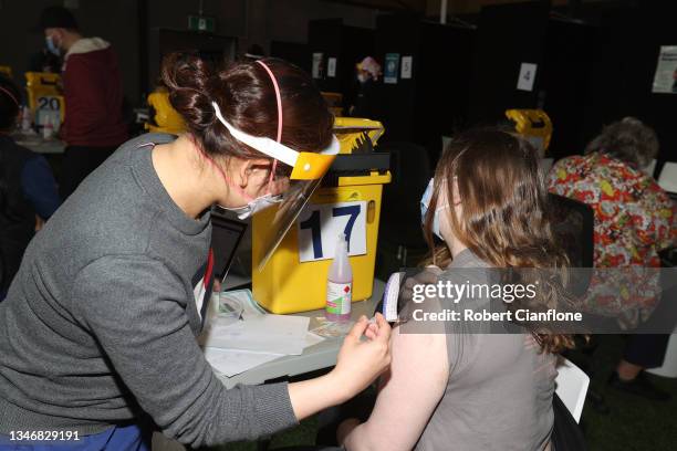 Nurse administers a COVID-19 vaccination at the Casey Fields pop up vaccination clinic on October 16, 2021 in Melbourne, Australia. Metropolitan...