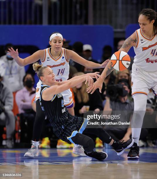 Courtney Vandersloot of the Chicago Sky falls as she passes between Bria Hartley and Brittney Griner of the Phoenix Mercury during Game Three of the...