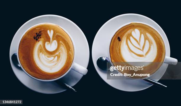 table top view of couple cup of hot latte coffee on table. - mokka stock-fotos und bilder