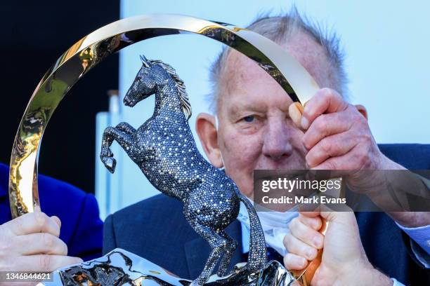 The winning owner of Nature Strip is seen through the trophy after winning race 7 The Tab Everest during Everest Day at Royal Randwick Racecourse on...