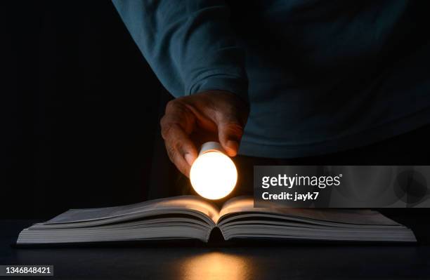 ideas lightbulb - glowing book stock pictures, royalty-free photos & images