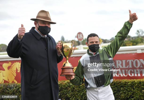 Brett Prebble and Trainer Peter Moody pose with the Caulfield Cup after Incentivise won Race 9, the Carlton Draught Caulfield Cup, during Caulfield...