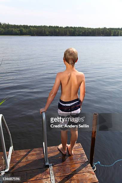 blonde boy standing on dock ready for bath - uppsala stock-fotos und bilder