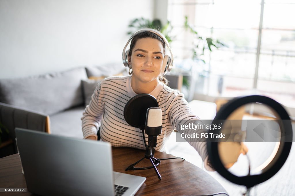 Young woman doing a live broadcast at home