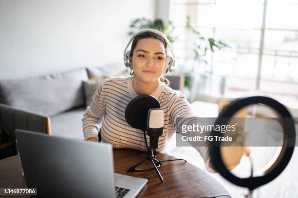 young woman doing a live broadcast at home - filming stock pictures, royalty-free photos & images