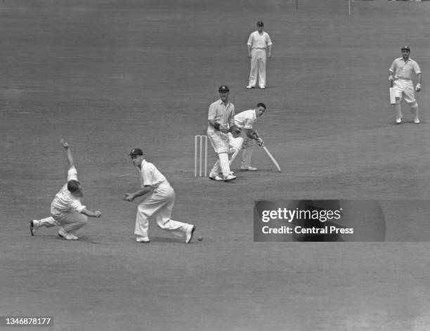 West Indies batsman Robert Christiani looks past England wicketkeeper Godfrey Evans as his shot is dropped by slip fielders Doug Insole and Gilbert...