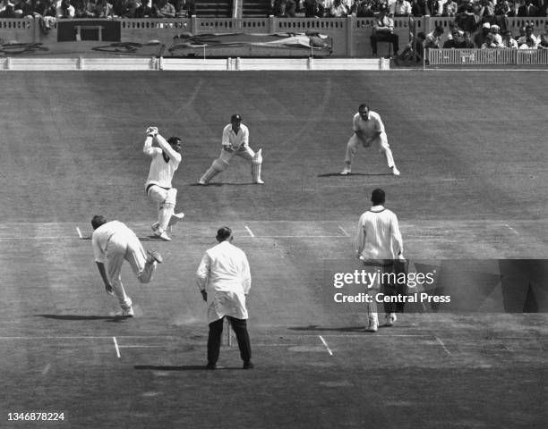 England wicketkeeper Jim Parks and slip fielder Colin Cowdrey look on as batsman Garfield Sobers, captain of the West Indies cricket team plays a...