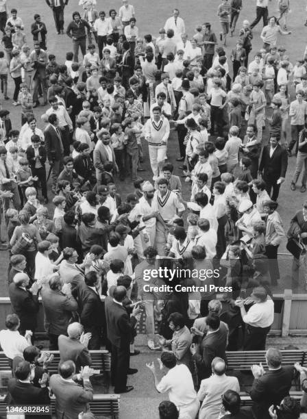 Bhagwath Chandrasekhar of India, surrounded by fans leads wicketkeeper Farokh Engineer, bowler Bishan Singh Bedi and the rest of the team up the...