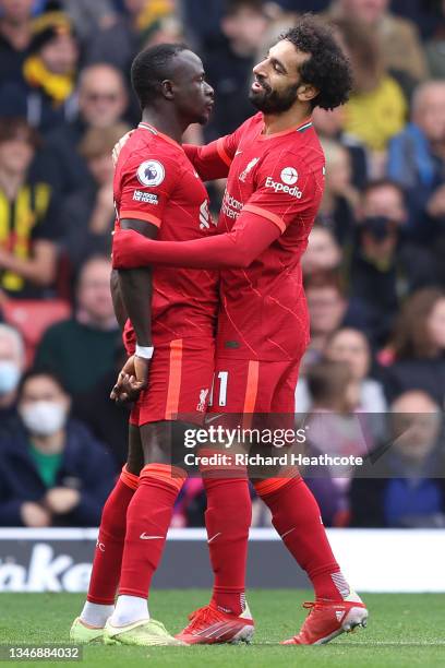 Sadio Mane of Liverpool is celebrates with teammate Mohamed Salah after scoring their side's first goal during the Premier League match between...