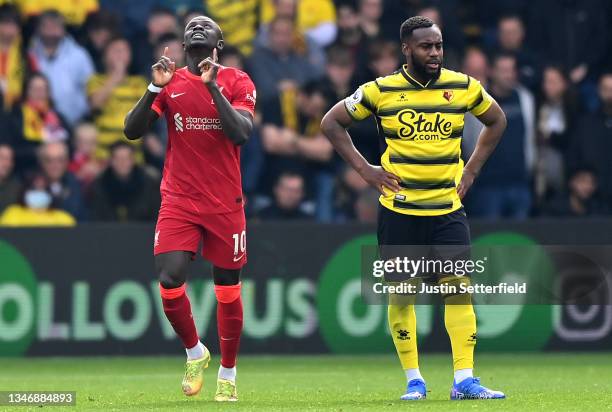 Sadio Mane of Liverpool celebrates after scoring his sides first goal as Danny Rose of Watford looks on during the Premier League match between...