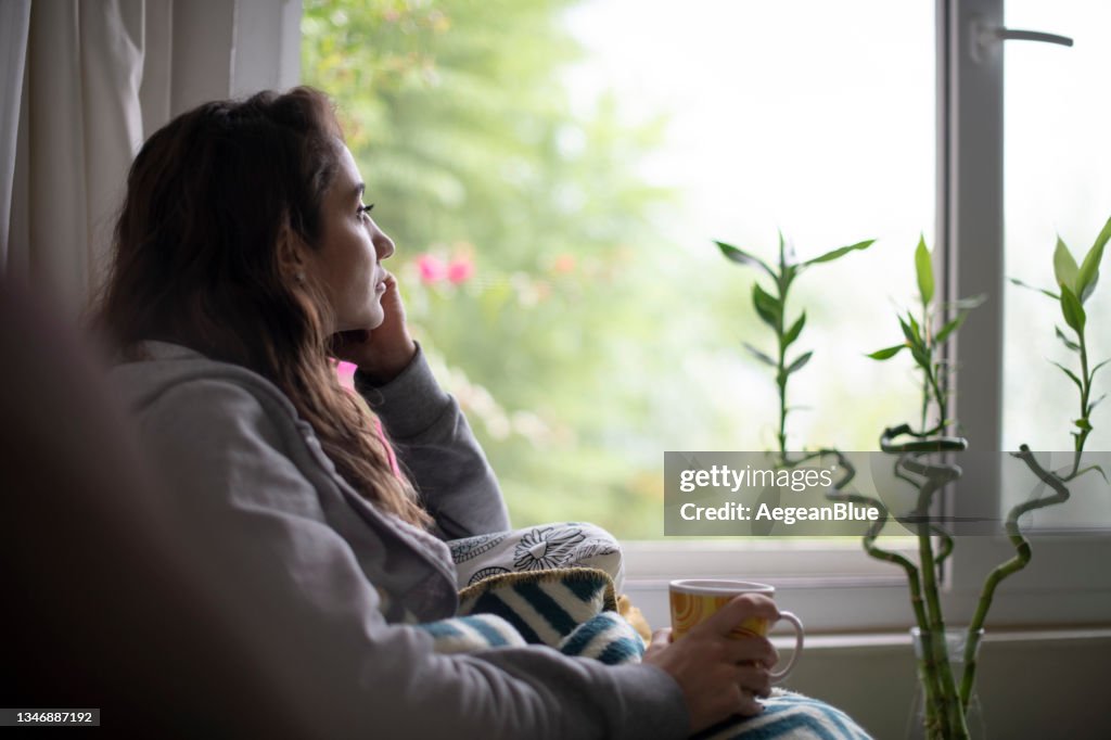 Depressed Woman Sitting by Window