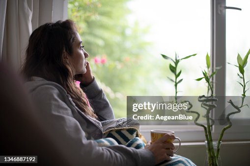 Depressed Woman Sitting by Window Depressed Woman Sitting by Window