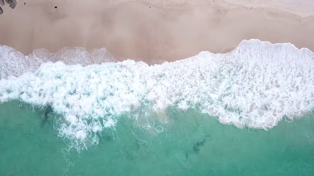Aerial view of Tropical Beach and wave with white sand and blue sea , 4K(UHD) , Vacation and Travel Concept