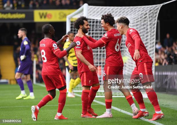 Mohamed Salah of Liverpool celebrates with teammates Naby Keita, Trent Alexander-Arnold and Roberto Firmino after scoring their side's fourth goal...