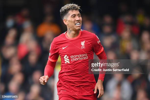 Roberto Firmino of Liverpool celebrates after scoring their side's third goal during the Premier League match between Watford and Liverpool at...