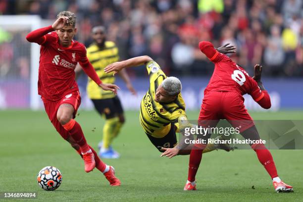 Cucho Hernandez of Watford FC is challenged by Roberto Firmino and Naby Keita of Liverpool during the Premier League match between Watford and...