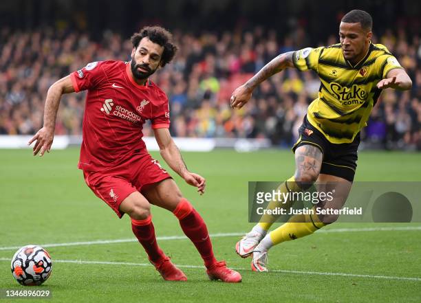 Mohamed Salah of Liverpool is challenged by William Troost-Ekong of Watford FC during the Premier League match between Watford and Liverpool at...
