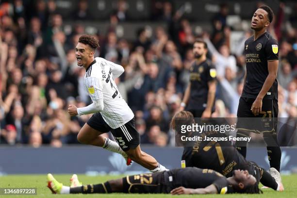 Antonee Robinson of Fulham celebrates after scoring their team's fourth goal as Chris Willock of Queens Park Rangers looks on during the Sky Bet...