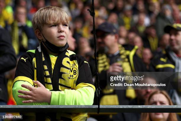 Young fan looks on during the Bundesliga match between Borussia Dortmund and 1. FSV Mainz 05 at Signal Iduna Park on October 16, 2021 in Dortmund,...