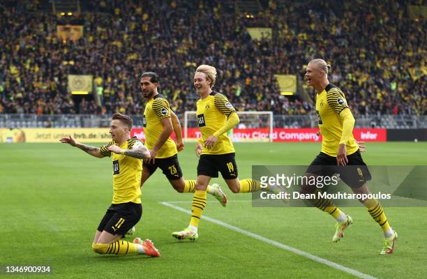 Marco Reus celebrates with teammates Emre Can, Julian Brandt and Erling Haaland of Borussia Dortmund after scoring their team's first goal during the...