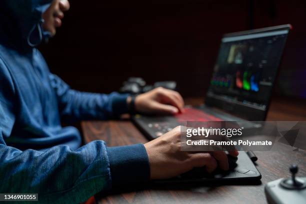 a man working on computer with video editing and color correction. film making. content creator. video production. equipment filmmaking. - video editing foto e immagini stock