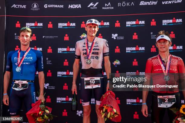 Leon Chevalier of France , Florian Angert of Germany and Cameron Wurf of Australia celebrate their results on the podium during the Men's race of...