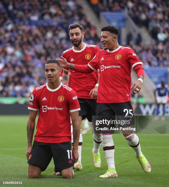 Mason Greenwood of Manchester United celebrates with teammates Jadon Sancho and Bruno Fernandes after scoring their side's first goal during the...