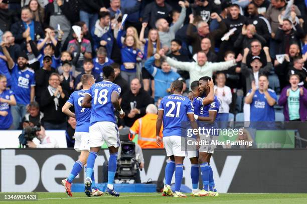 Youri Tielemans of Leicester City celebrates with teammate Kelechi Iheanacho after scoring their side's first goal during the Premier League match...